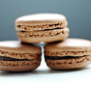 Close-up of stacked chocolate macarons showcasing their texture and filling.
